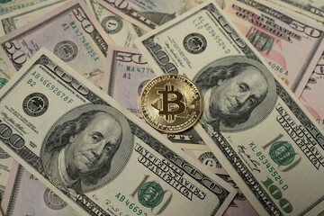 Golden Bitcoin on top of Dollar Banknotes. Digital Crypto currency and fiat Money. US Dollar Cash. USD Background and BTC coin in center