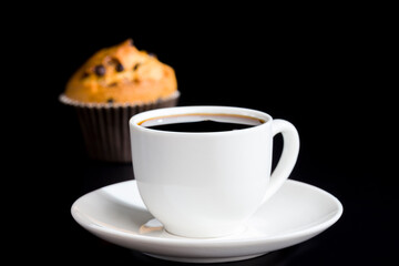 a delicious fresh bun and a cup of black aromatic coffee