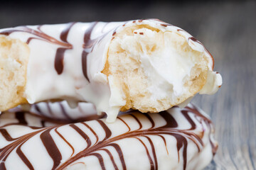 a fresh doughnut covered with white chocolate , closeup