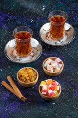 Vertical photo of Fragrant tea and delights on blue background