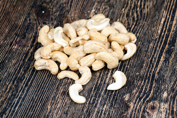 cashew nuts on an old wooden table, close up