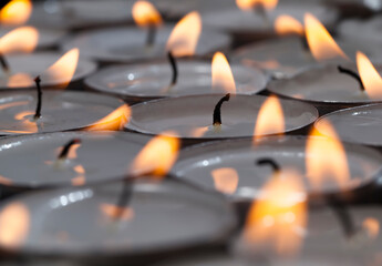 a large number of small candles burning together