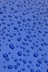 Water drop on blue surface