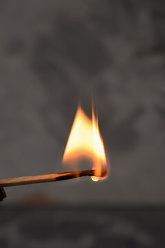 fire.a burning match.gray concrete background.macro