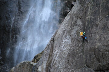 Yosemite rock climber beside mountain waterfall