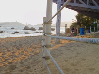 a rope fence on the beach in the afternoon