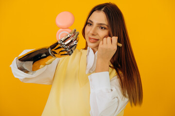 Attractive long haired woman with stylish bionic arm applies makeup looking in pocket mirror on...