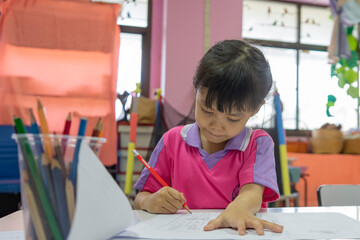 Students sitting and doing exercises in the classroom. Back to school.