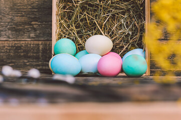 Close-up, a bunch of eggs with hay Against the background of a vintage board.