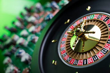 Casino. Gambling games theme.  Roulette wheel, dice and poker chips on the casino felt green table.