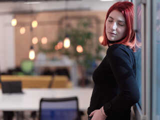 redhead business woman portrait in creative modern coworking startup open space office