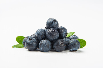 Fresh blueberry with drops of water on white background