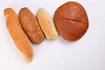 Freshly baked bread loaf bun roll round long mix verity copy text space border frame white background