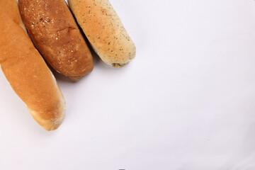 Freshly baked bread loaf bun roll round long mix verity copy text space border frame white background