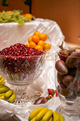 Catered Wedding Fruit Table with Pomegranate Seeds, Oranges, Prickley Pears, Bananas, Grapes and...