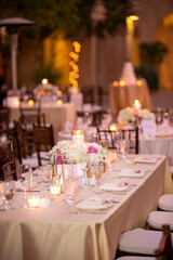 Table settiings for a large wedding ceremony in an outdoor patio area