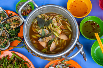 Delicious Vietnamese local street food - snails dishes on table