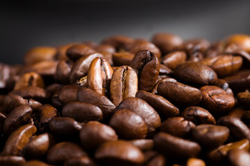 whole and flavorful coffee beans scattered in a chaotic order