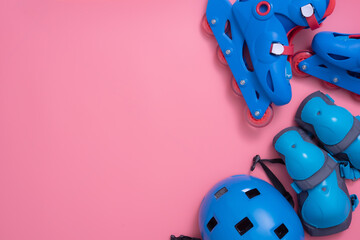 Kids rollerblade,roller skating and body parts protection on pink background,top view