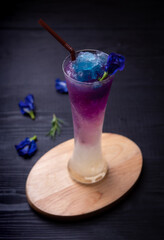 Butterfly pea or blue pea juice ice cool drink on wooden table