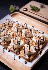 Roti desserts with whipped cream and nut on wood