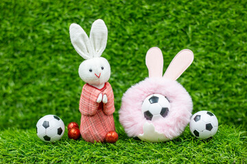 Soccer Easter Holiday with rabbit and Easter eggs on green grass