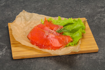 Sliced salmon fillet served rosemary