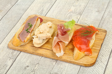 Tapas - bruschetta with prosciutto, salmon, duck and gorgonzola