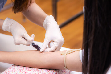 Close-up Hand of nurse, doctor or Medical technologist with gloves holding syringe to taking blood...