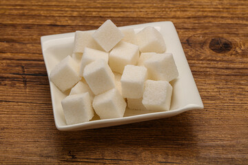 Refined white sugar cubs in the bowl