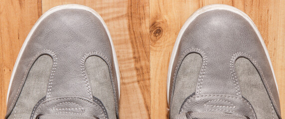 Comfortable gray leather shoes on rustic board, male footwear
