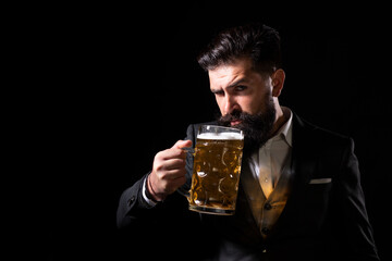 Hipster with beard and mustache in suit drinks beer after working day. Germany Bavaria. Beer time....