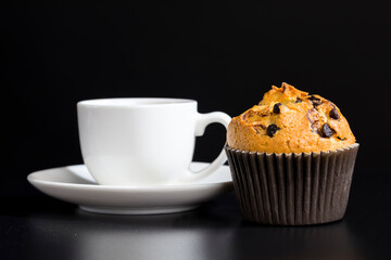 a delicious fresh bun and a cup of black aromatic coffee