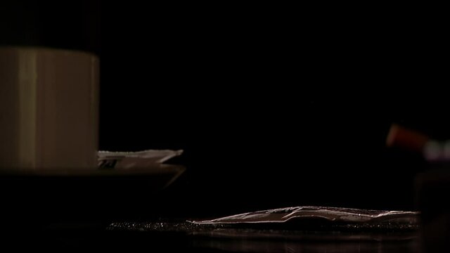 Male Hand Grabbing Lighter and Cigarettes in Argentine Caf&eacute; - Close Up