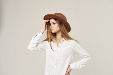 Pretty woman in hat white shirt elegant style fashion light background