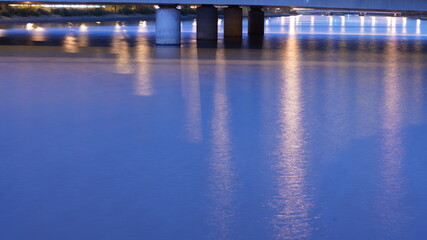 The city night view with the lights on and the reflection in river in the evening