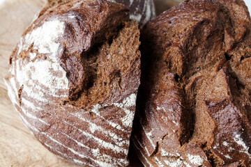 black rye bread divided into parts, fresh and soft bread