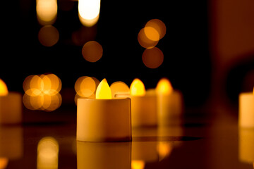 A Close up picture of an Electric LED candle against the dark background with bokeh effect in decoration for Diwali festival in India.