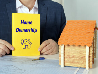 Business concept meaning Home Ownership with sign on yellow book