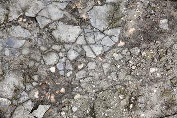 The remains of cracked asphalt on the ground. Top view