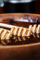 dipped in honey spoon , close up