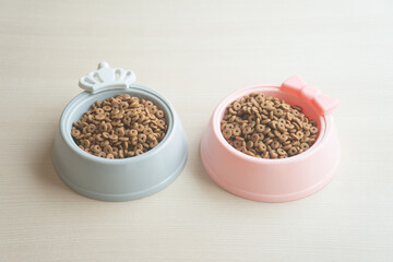 Obraz na płótnie Canvas Dry dog food in bowl on wooden table
