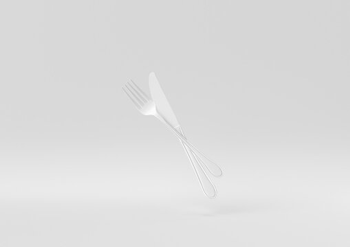 White Fork and knife floating in white background. minimal concept idea creative. monochrome. 3D render.