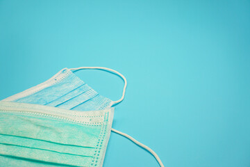 Face mask On a blue background, wear to prevent coronavirus infection (COVID-19).