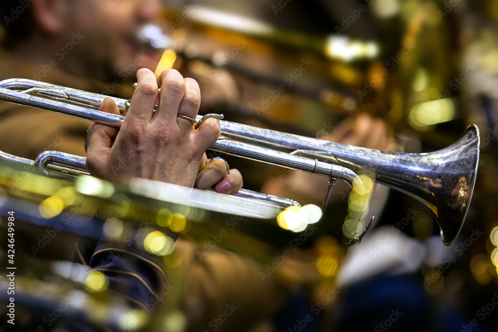 Wall mural hands of a musician playing the trumpet in the orchestra close up