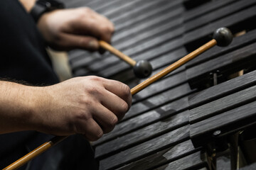 Hands of a musician playing the xylophone in black and white 