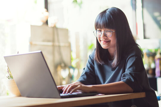 asian teenager working on computer laptop