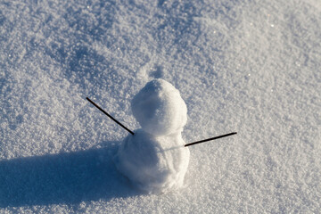 one small snowman in the winter season, close up