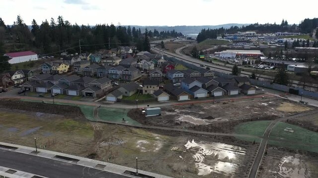 Cinematic bird's-eye rise and reveal footage of a new development construction in Bremerton in Kitsap County, Washington State