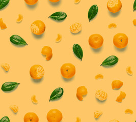 Tangerine orange seamless pattern. Isolated mandarin pieces on white background. Flat lay of whole and half tangerines, peeled mandarins and leaves.